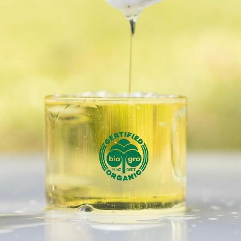 Native Tree Farm organic certified manuka essential oil is being poured in a glass jar.