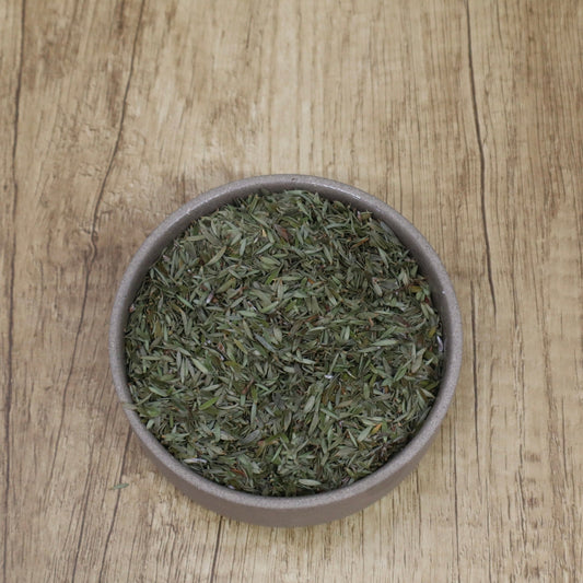 dried mānuka leaves in a bowl on a wooden table