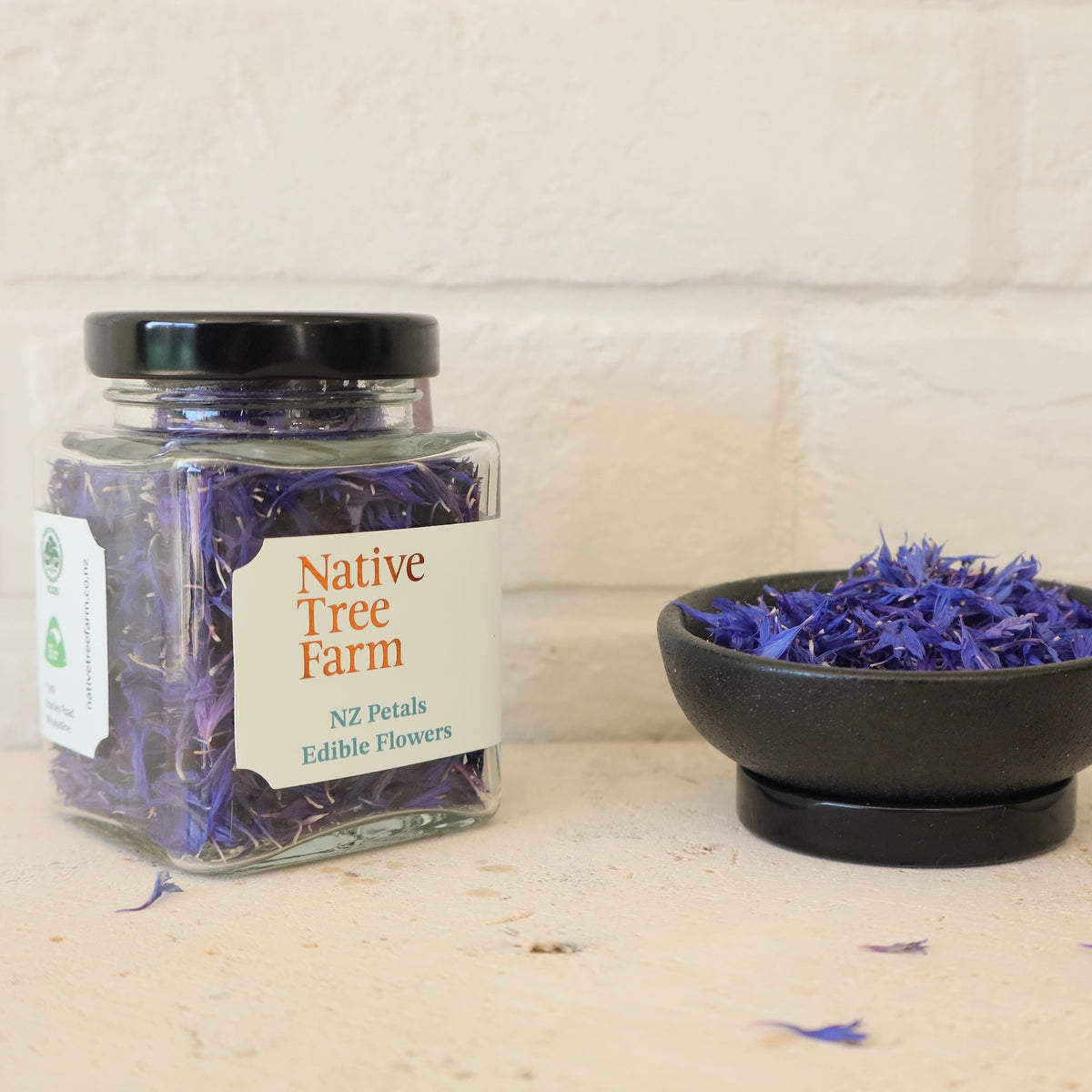 a bowl of Native Tree Farm blue and purple edible petals on a kitchen bench