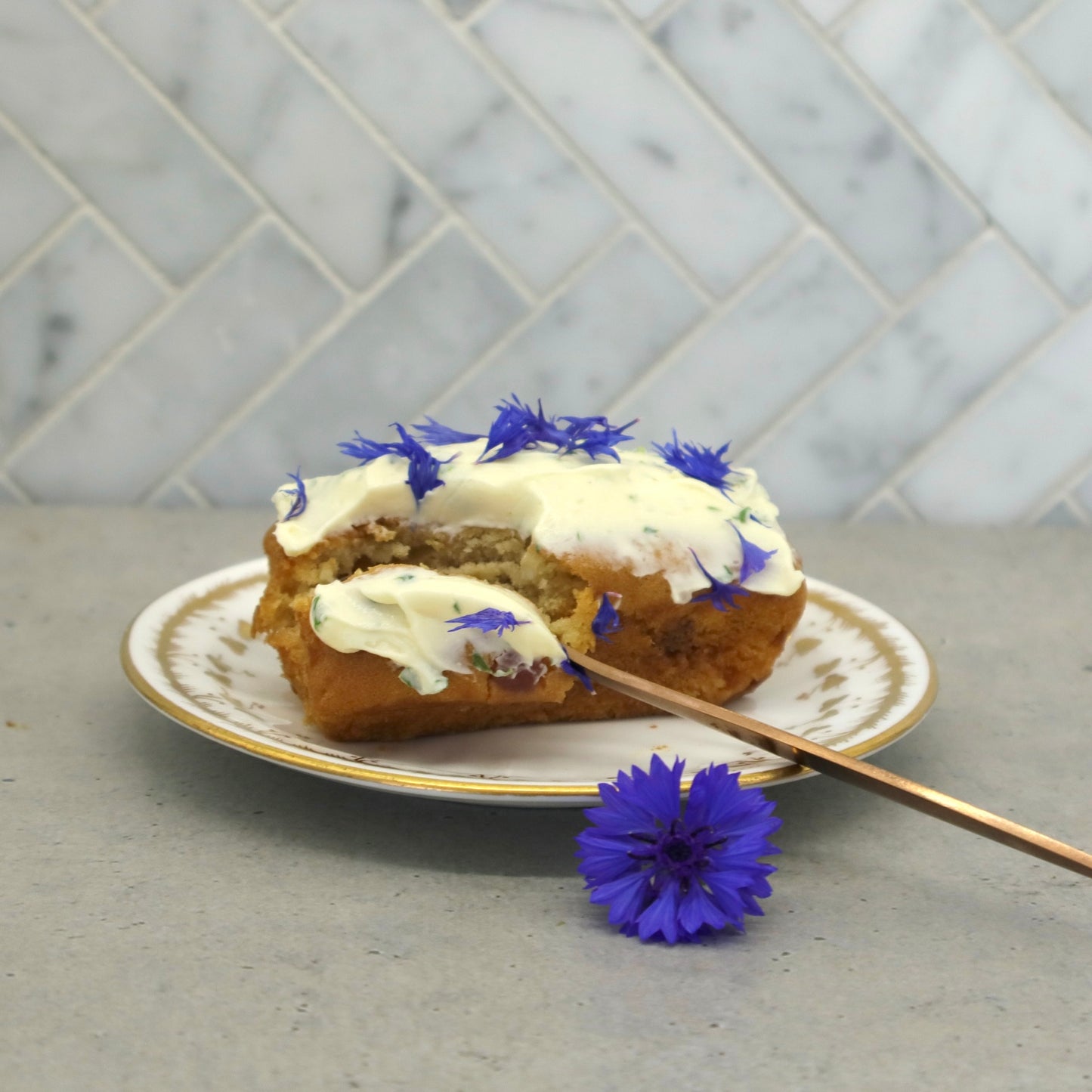 Native Tree Farm's certified organic blue edible flower petals decorated on a cake sitting on the kitchen table