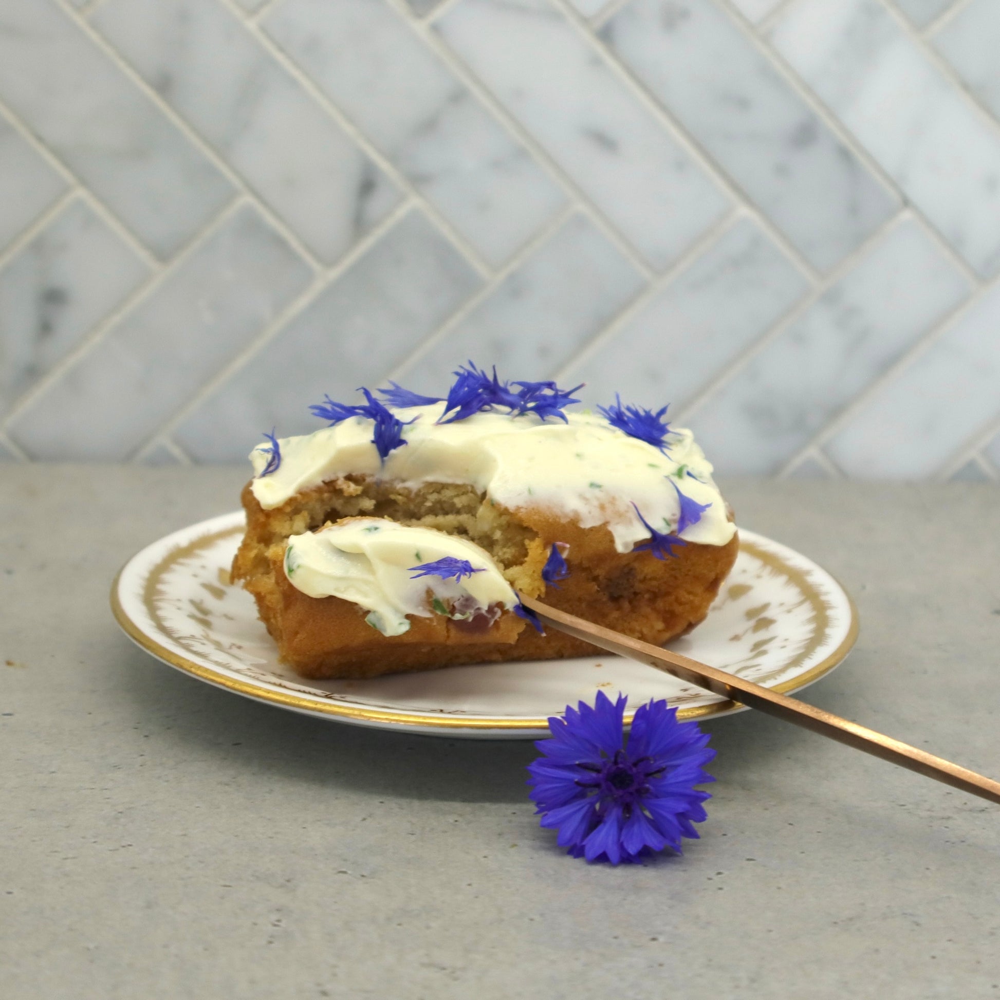 Native Tree Farm's certified organic blue edible flower petals decorated on a cake sitting on the kitchen table