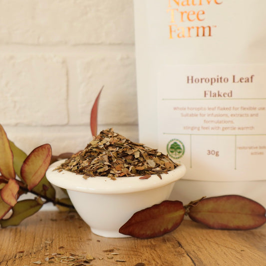 Horopito Leaf Flaked in a white bowl with 'Native Tree Farm' packaging in the background.