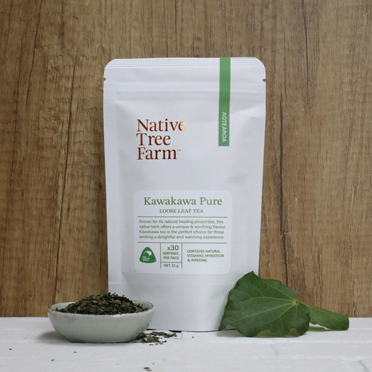 Native Tree Farm Kawakawa Pure loose leaf tea package with a bowl of tea leaves and a leaf on a wooden background