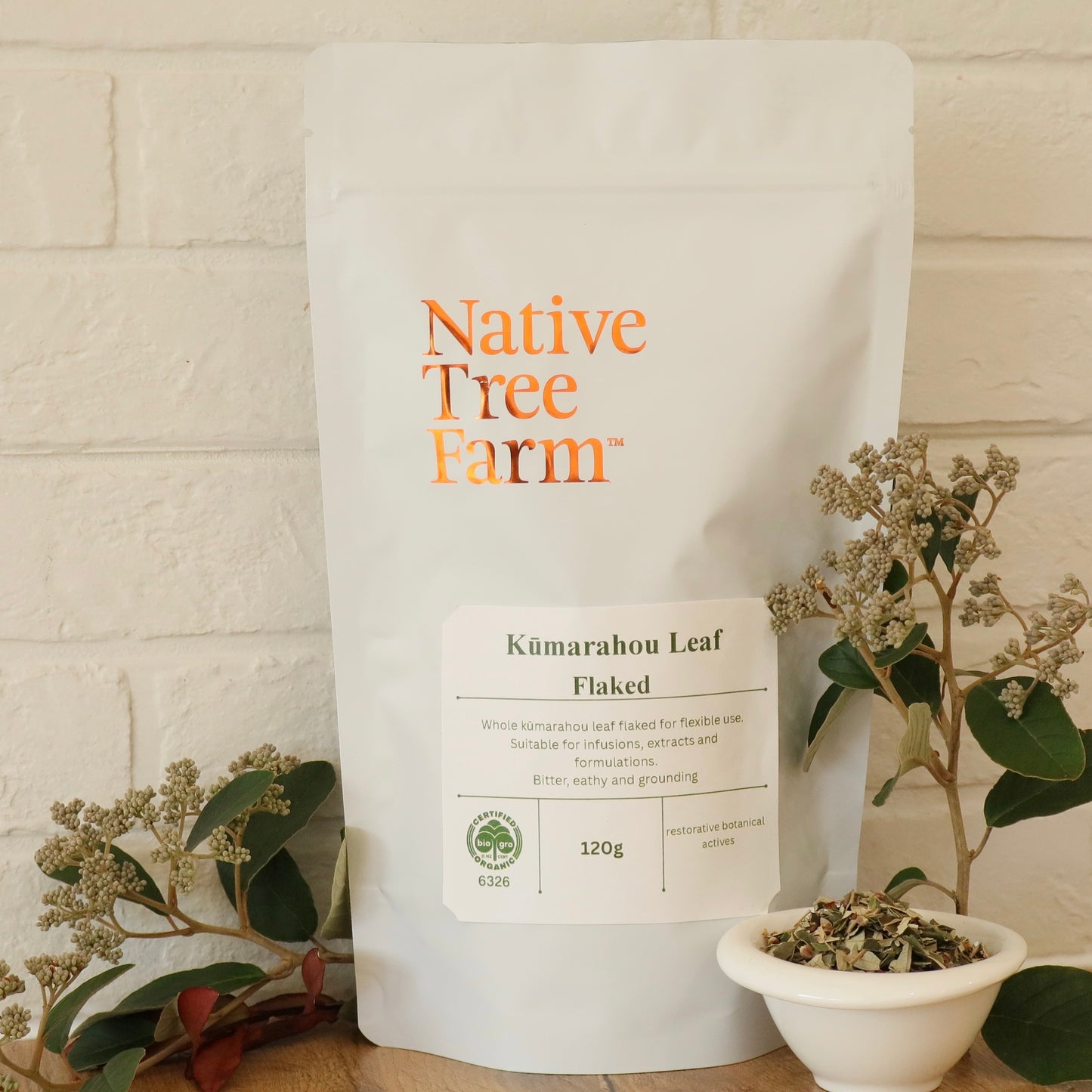 Native Tree Farm Kumarahou Leaf Flaked sitting on a kitchen bench with a white brick background