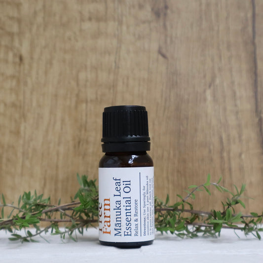 Bottle of Manuka Leaf Essential Oil with a wooden background