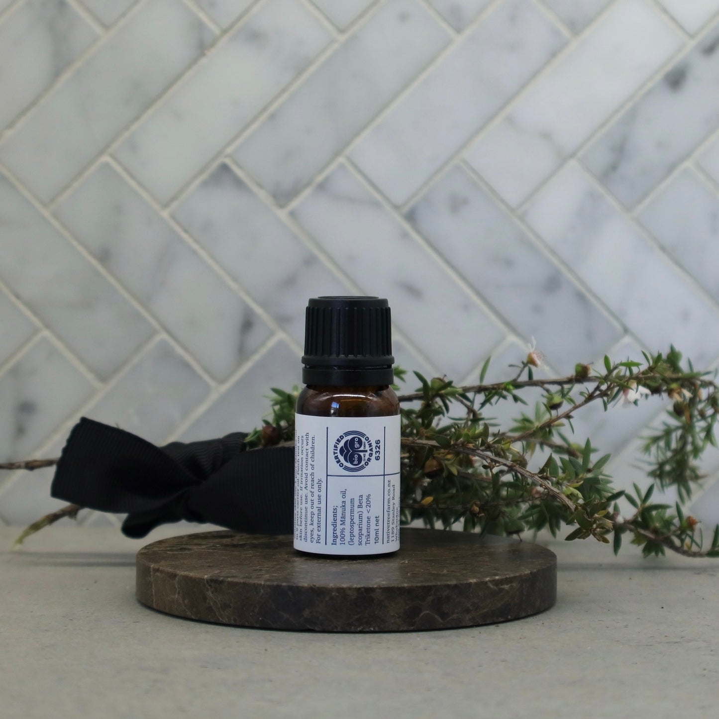  the back of a bottle of Native Tree Farm's manuka oil showing the ingredients and the instructions on how to use the oil