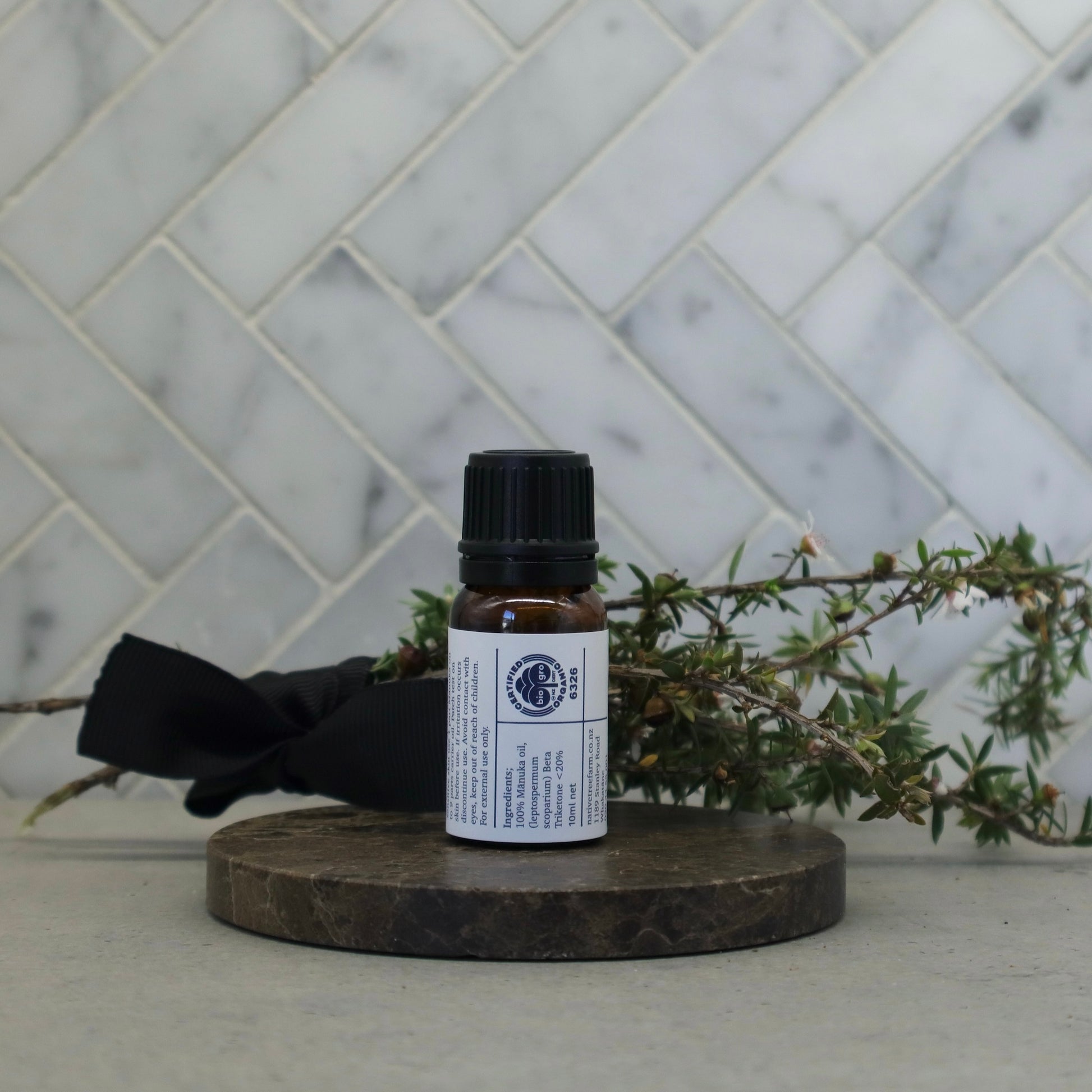  the back of a bottle of Native Tree Farm's manuka oil showing the ingredients and the instructions on how to use the oil