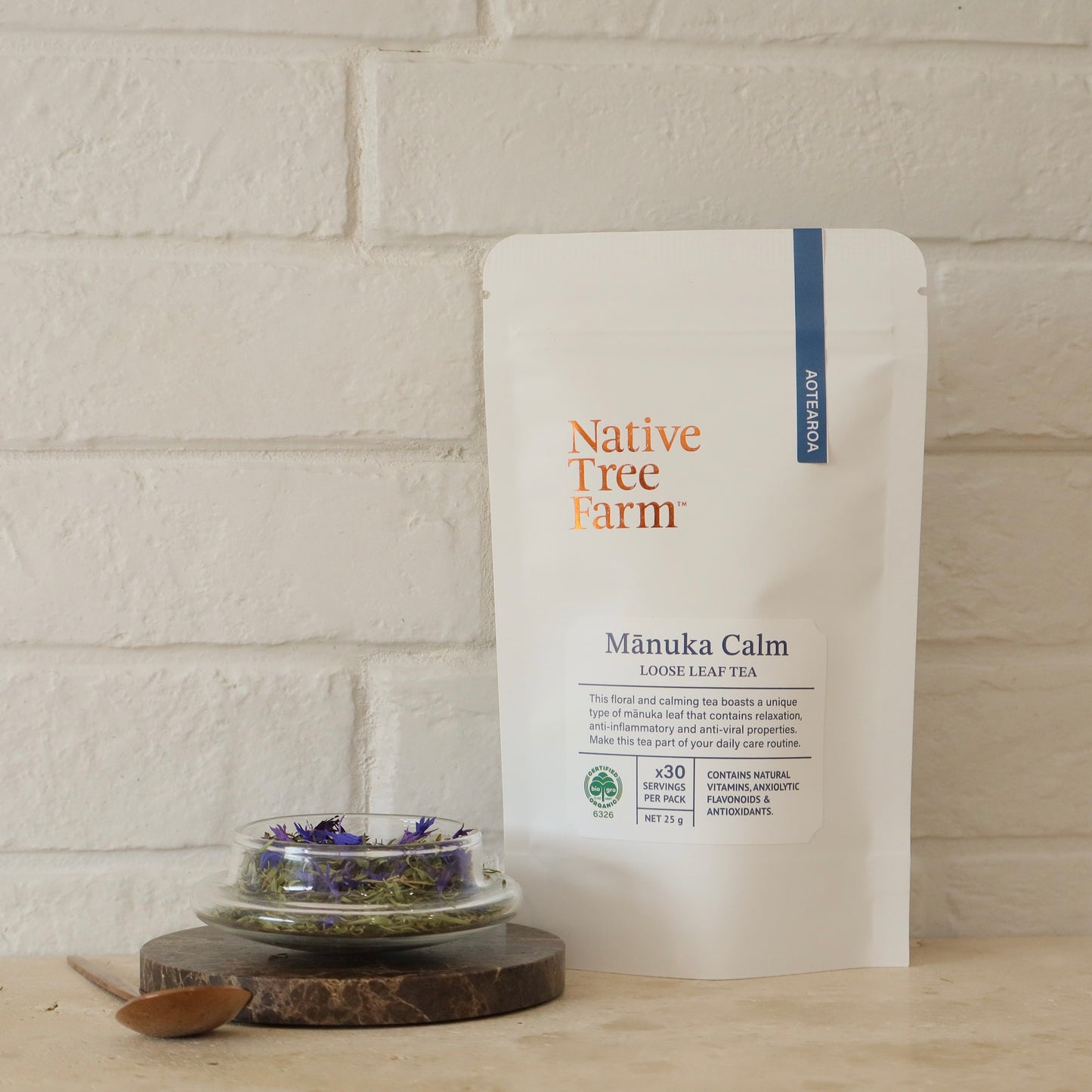 Manuka Calm loose leaf tea packaging by Native Tree Farm on a white brick wall background.